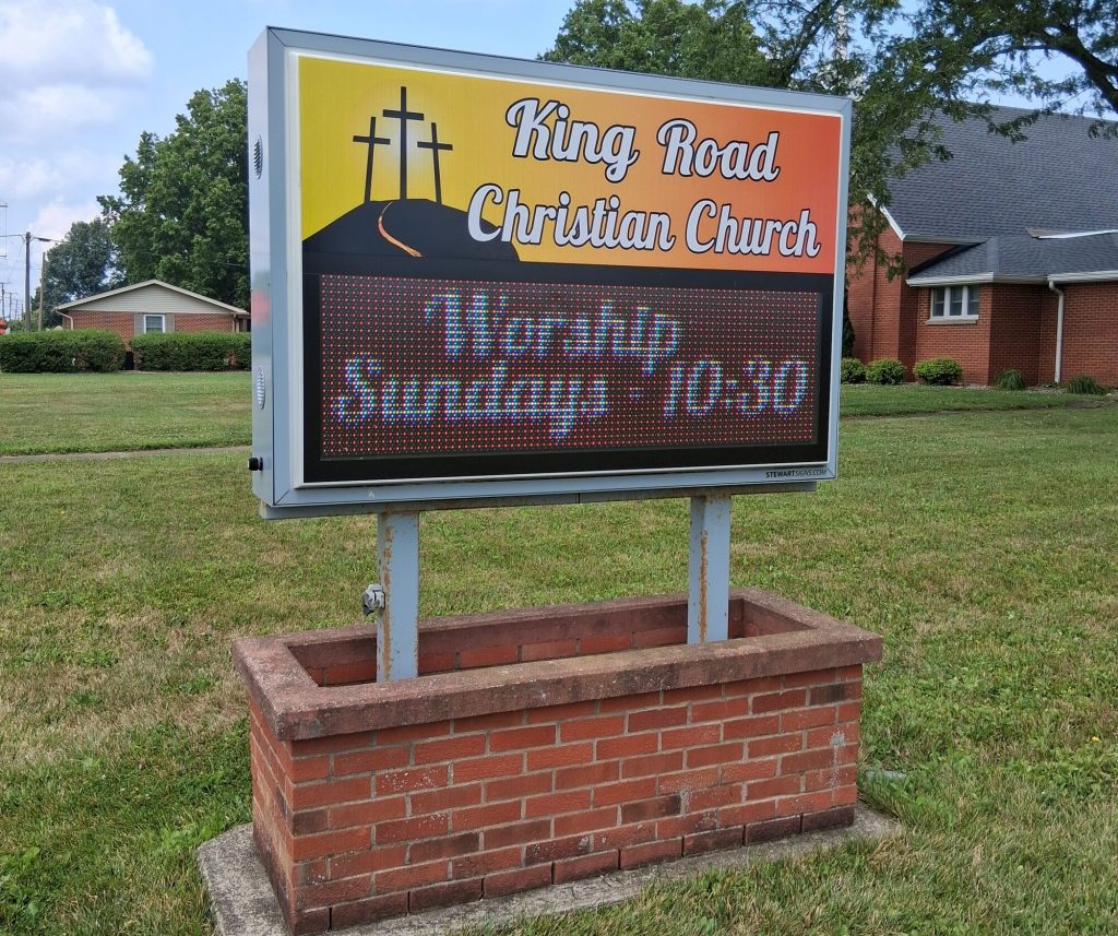 The King Road Christian Church sign on King Road, with the church behind it